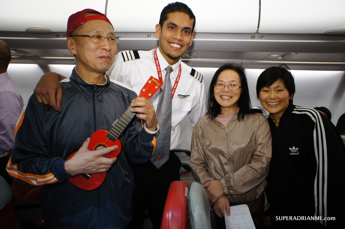 AirAsia X D7 535 2 Dec 2011 - Senior First Officer Raveen takes photos with Passengers