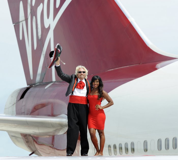 Sir Richard Branson and singer Alexabra Burke on the wing of a Virgin 747 after it touched down in Cancun, Mexico. [Photo credit: David Dyson]