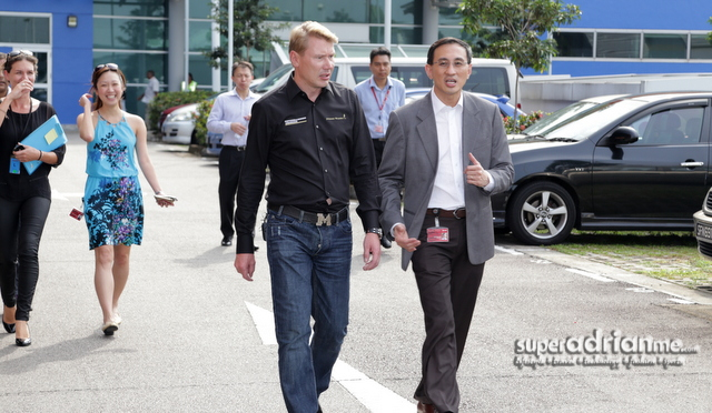 Mika Häkkinen walks with Desmond Kuek, President and CEO, SMRT Corporation Ltd.