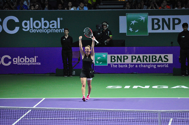 Halep raises her hands in joy after her biggest win of her career (Photo by Sean Long)