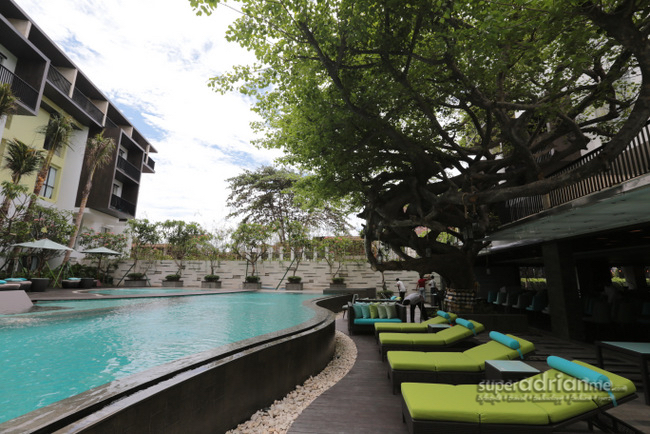 Mercure Legian Bali - Tan on the sun deck chairs by the pool and Ancak Restaurant & Lounge.