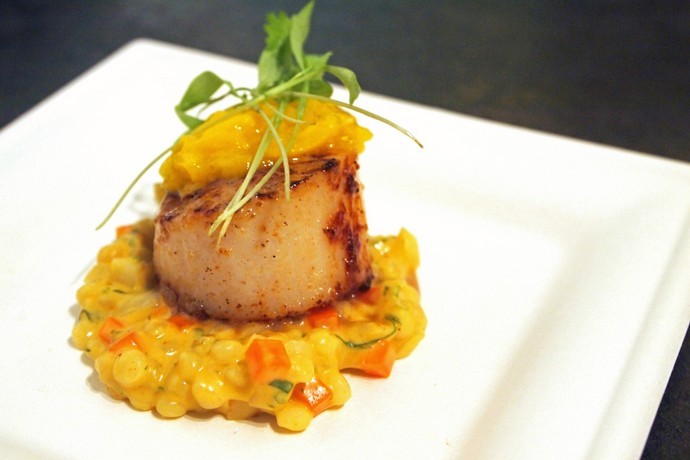Perfectly seared Fresh Hokkaido Scallop on top a bed of curried couscous