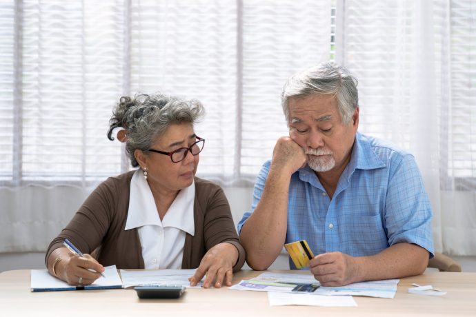 Elderly Asian couples suffering from debt problems, Living after retirement. | SUPERADRIANME.com iStock Photo/Panupong Piewkleng